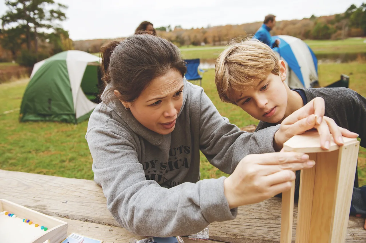 A Scouting family working together on a hands-on project